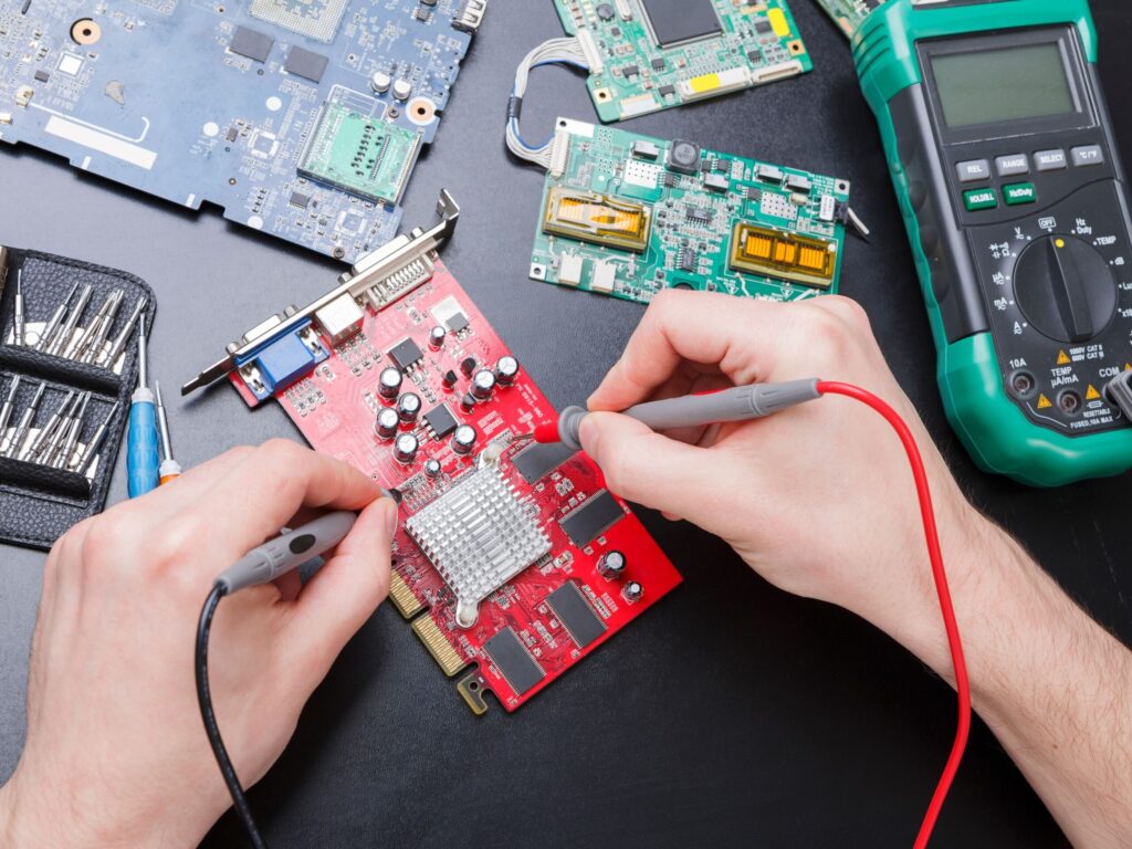 Hands using probes on circuit board symbolizing curiosity and continuous improvement