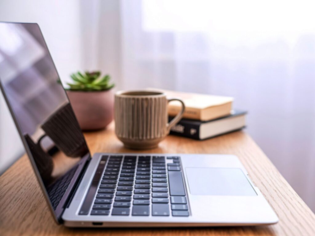 Minimalist desk with open laptop, books, and coffee mug representing focus and productivity