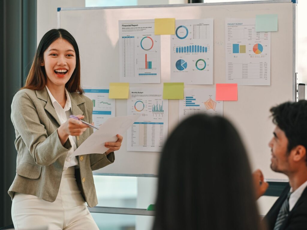 Engineer presenting data and ideas to colleagues during a meeting.