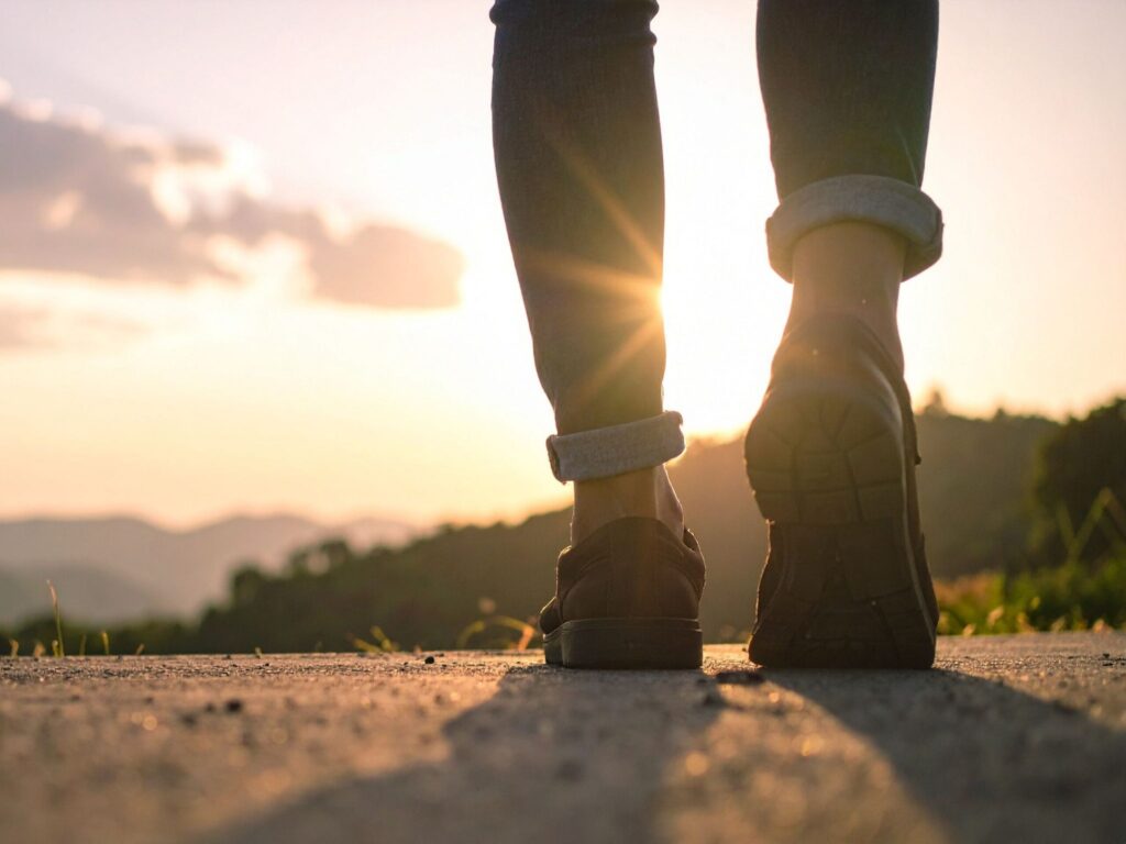 Engineer walking toward sunrise on an open road representing career growth and opportunity.
