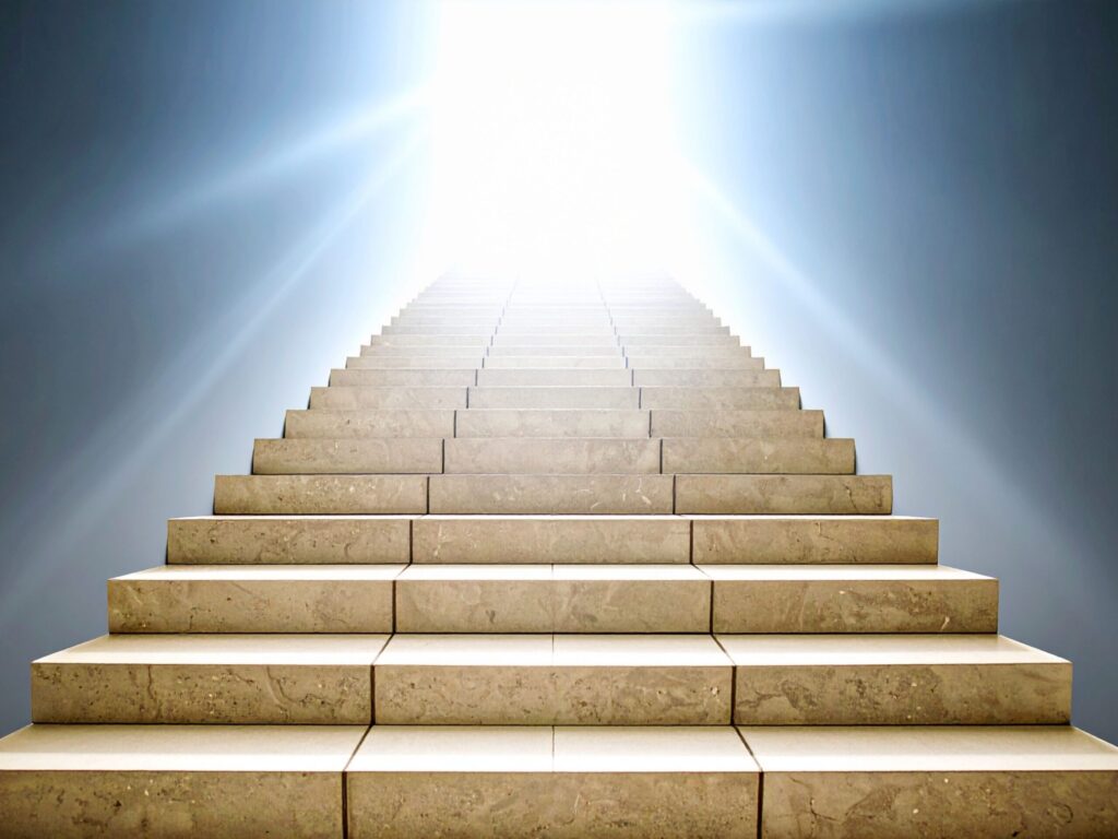 Staircase leading upward into bright daylight symbolizing career growth and clarity.
