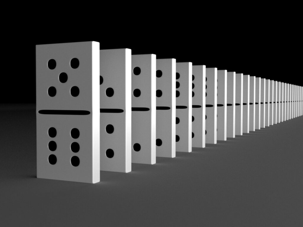 Row of dominoes standing in line symbolizing consistency and reliability