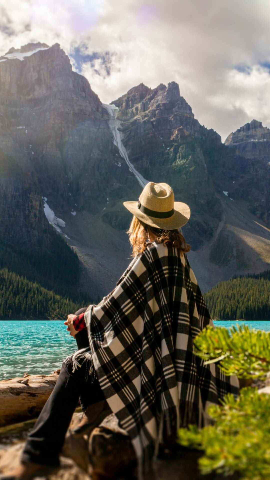 Finding Clarity in Nature: Reflective Moment by Mountain Lake Person sits by a mountain lake reflecting on life changes inspired by purpose driven coaching